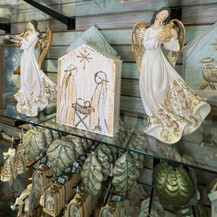 Decorative angel figurines on a glass shelf  in the moments in thyme room at Dewayne's in Selma, NC