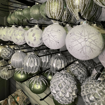 Decorative light green Christmas ornaments hanging  in the moments in thyme room at Dewayne's in Selma, NC