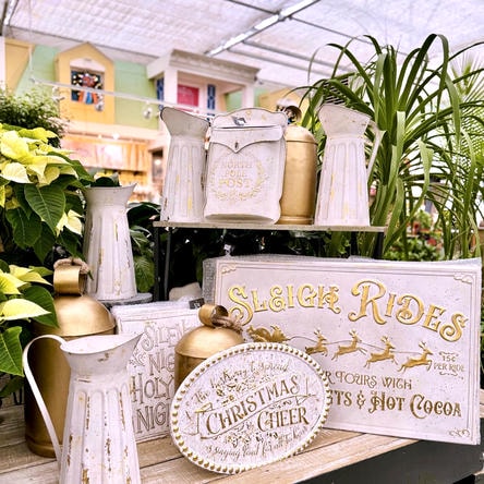 Decorative Christmas white and gold signs and pitchers in a greenhouse at Dewayne's in Selma, NC minutes from Raleigh, Cary, Clayton, Garner, Smithfield, Goldsboro