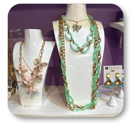  green and gold necklace with floral design, surrounded by other zenzii  jewelry in the boutique at Dewayne's in Selma, NC minutes from Raleigh, Cary, Clayton, Garner, Smithfield, Goldsboro