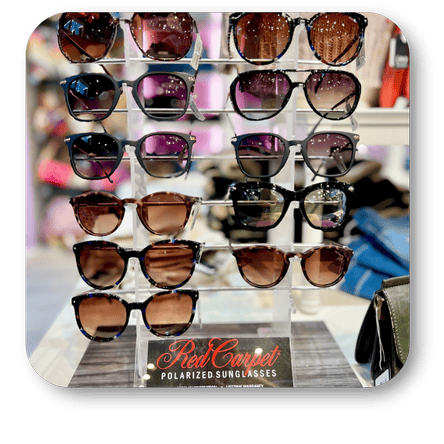 Display of sunglasses on a stand with 'Red Carpet Polarized Sunglasses' branding in the boutique at Dewayne's in Selma, NC minutes from Raleigh, Cary, Clayton, Garner, Smithfield, Goldsboro