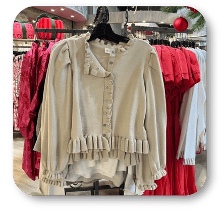 Beige blouse with ruffled details on a hanger in the boutique at Dewayne's in Selma, NC minutes from Raleigh, Cary, Clayton, Garner, Smithfield, Goldsboro