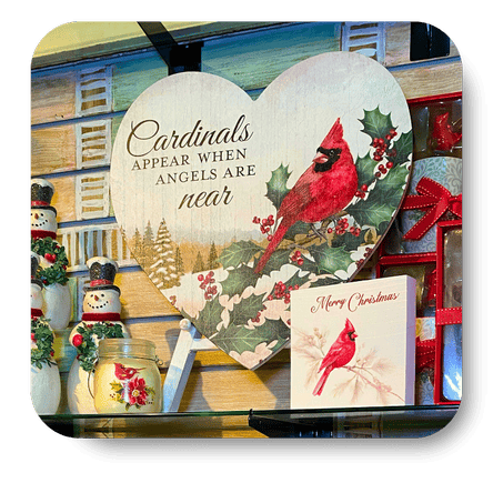 Collection of Christmas-themed decor items including cardinals, snowmen, and festive signs in christmas land at Dewayne's in Selma, NC minutes from Raleigh, Cary, Clayton, Garner, Smithfield, Goldsboro