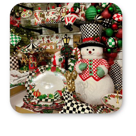 Decorative Christmas scene with a snowman figurine, candy canes, and festive tableware in the grand entrance of Christmas Land at Dewayne's in Selma, NC minutes from Raleigh, Cary, Clayton, Garner, Smithfield, Goldsboro