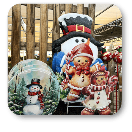 Decorative Christmas signs with gingerbread people and snowman against a blurred indoor background at Dewayne's in Selma, NC minutes from Raleigh, Cary, Clayton, Garner, Smithfield, Goldsboro