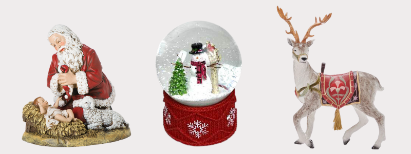Sample products of Three Christmas-themed figurines including Santa Claus, a snow globe with a snowman, and a deer on a light gray background found in the grand entrance room of Christmas land 2025 at Dewayne's