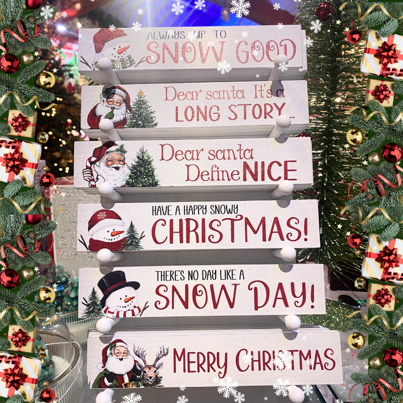 Decorative whimsical Christmas signs with humorous Santa and snowman-themes