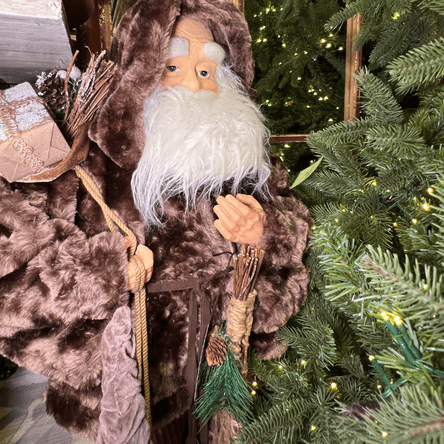 Woodsy Santa figure in a fur coat next to a decorated Christmas tree in the country christmas room at Dewayne's in Selma, NC