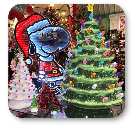 Decorative Christmas trees and a Snoopy light-up figure in a festive setting in the grand entrance room of Christmas land 2025 at Dewayne's in Selma, NC minutes from Raleigh, Cary, Clayton, Garner, Smithfield, Goldsboro