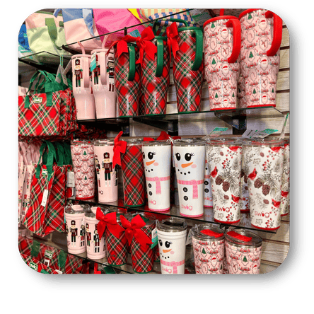Display of Christmas-themed tumblers and mugs with plaid patterns and festive designs at Dewayne's in Selma, NC minutes from Raleigh, Cary, Clayton, Garner, Smithfield, Goldsboro
