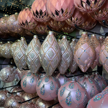 Decorative pink and gold Christmas ornaments  in the gold and glamour room in christmas land 2025 at dewayne's