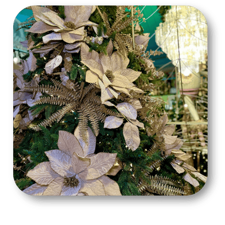 Decorative Christmas tree with gold and silver ornaments against a blurred indoor background in the gold and glamour room in christmas land 2025 at Dewayne's in Selma, NC minutes from Raleigh, Cary, Clayton, Garner, Smithfield, Goldsboro