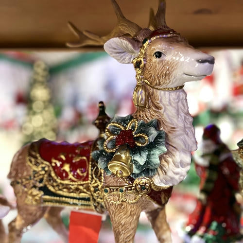 Decorative Fitz and floyd reindeer figure with gold antlers and a red saddle 