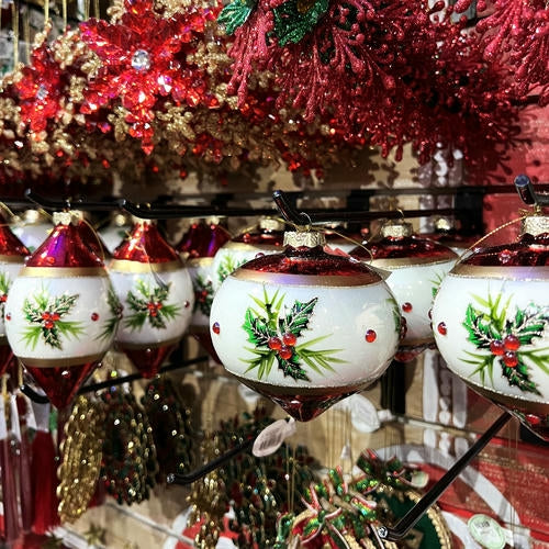 Decorative Christmas ornaments with holly design found in the grand entrance room of Christmas land 2025 at Dewayne's