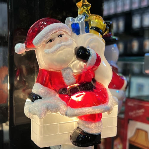 Decorative glass figure of Santa Claus night light in the rand entrance room of Christmas land 2025 at Dewayne's