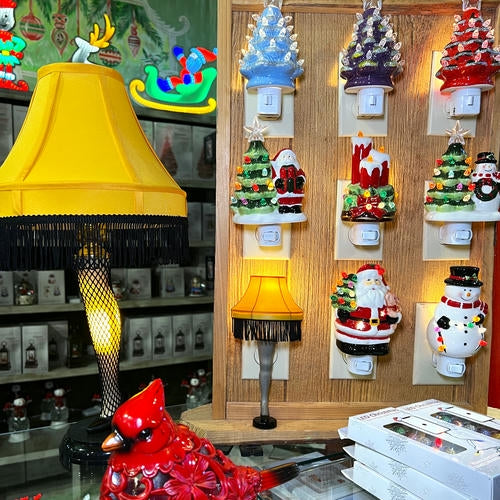 Decorative Christmas nightlights and a Christmas story yellow lamp on a wooden leg 