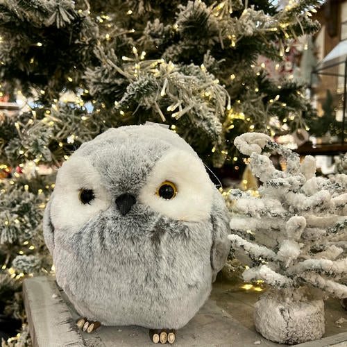 Plush owl toy in front of a decorated Christmas tree in the country Christmas room of Christmas Land 2025 at Dewayne's