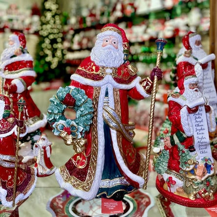 Decorative floyd & fitz Santa Claus figurines with a wreath in the grand entrance room in christmas land 2025 at dewayne's