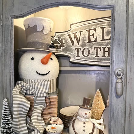 Decorative display with snowmen and a 'Welcome' sign in the country christmas room at Dewayne's in Selma, NC