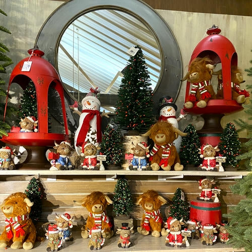 Display of Christmas-themed figurines, Highland cows and decorations with red lanterns and snowmen in the country Christmas room of Christmas Land 2025 at Dewayne's