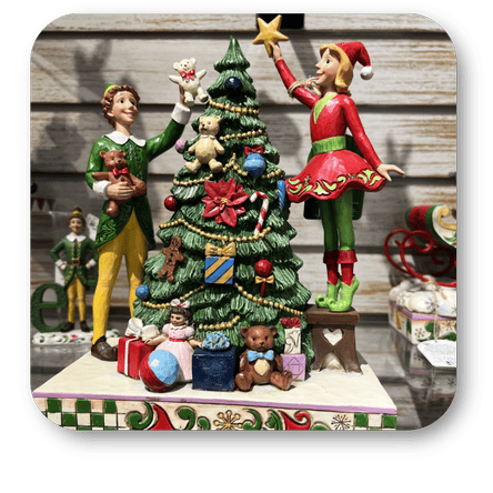 Decorative Christmas scene with elves and a tree in the Collection of Christmas-themed figurines by 'Jim Shore' in the timeless treasures room in christmas land at Dewayne's in Selma, NC minutes from Raleigh, Cary, Clayton, Garner, Smithfield, Goldsboro