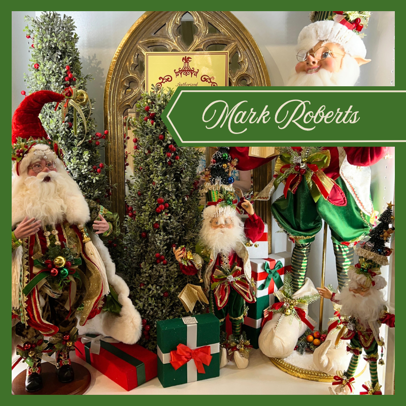 Decorative Christmas scene with Santa Claus, elves, and Christmas trees featuring Mark Roberts branding.