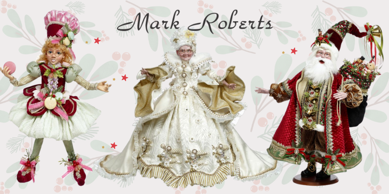 Three decorative figures, including a fairy, a woman in a white dress, and a man in a red suit, by the 'Mark Roberts' brand