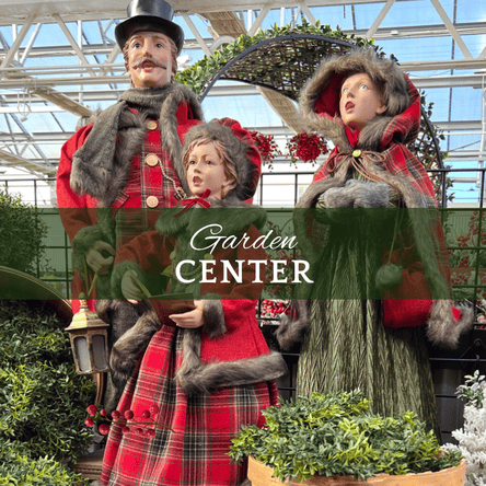 Decorative display with people in festive attire  surrounded by Christmas decorations  in the Garden center at Dewayne's in Selma, NC minutes from Raleigh, Cary, Clayton, Garner, Smithfield, Goldsboro