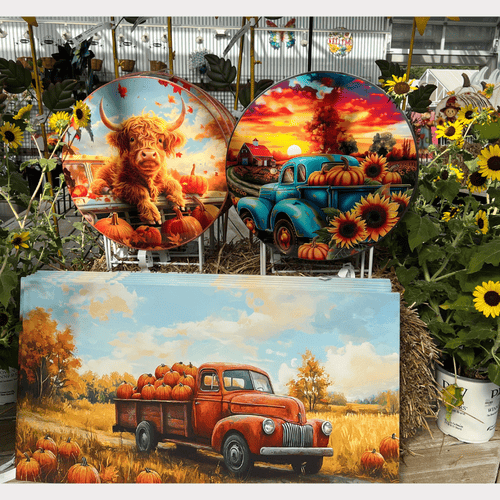Decorative yard signs featuring farm-themed designs with a truck, cow, and pumpkins in a greenhouse  at dewayne's