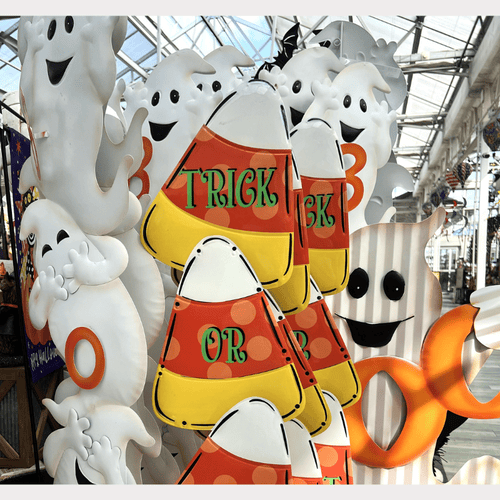 Halloween yard signs including ghost figures and candy corn with 'Trick or Treat' text in garden center at dewaynes