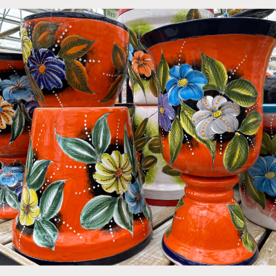 Decorative orange pots with floral designs by Talavera