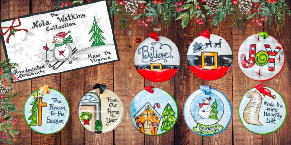 Decorative Christmas ornaments with holiday-themed designs on a wooden background, featuring the Nola Watkins Collection branding at Dewayne's in Selma, NC minutes from Raleigh, Cary, Clayton, Garner, Smithfield, Goldsboro