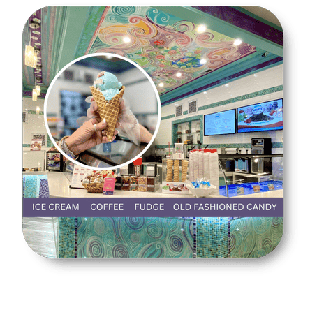 Ice cream shop interior with a person holding an ice cream cone, colorful ceiling, and menu board in the sweet shop at Dewayne's in Selma, NC minutes from Raleigh, Cary, Clayton, Garner, Smithfield, Goldsboro