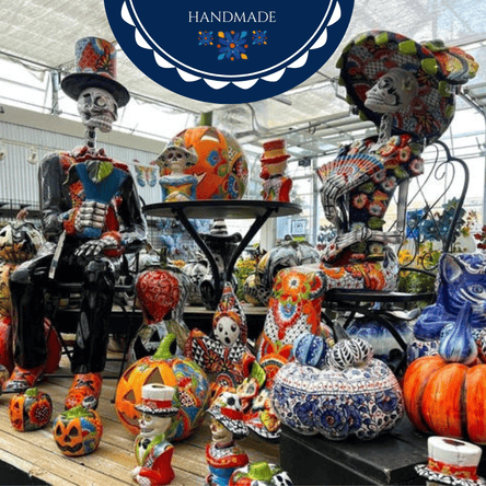 Colorful handmade Talavera ceramic figures and pumpkins displayed in a store setting with 'Handmade' label in the garden center at dewayne's
