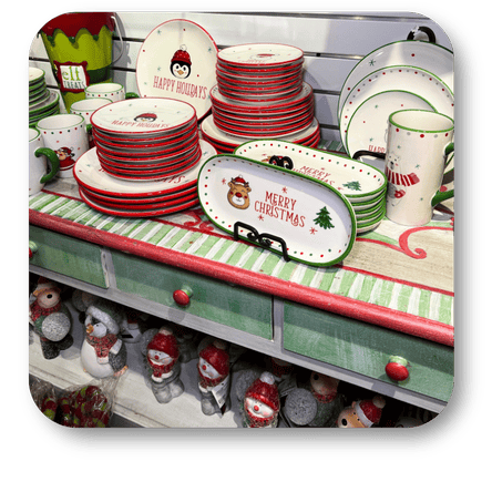 Display of Christmas-themed plates and platters on a store shelf  in santa's workshop at Dewayne's in Selma, NC minutes from Raleigh, Cary, Clayton, Garner, Smithfield, Goldsboro