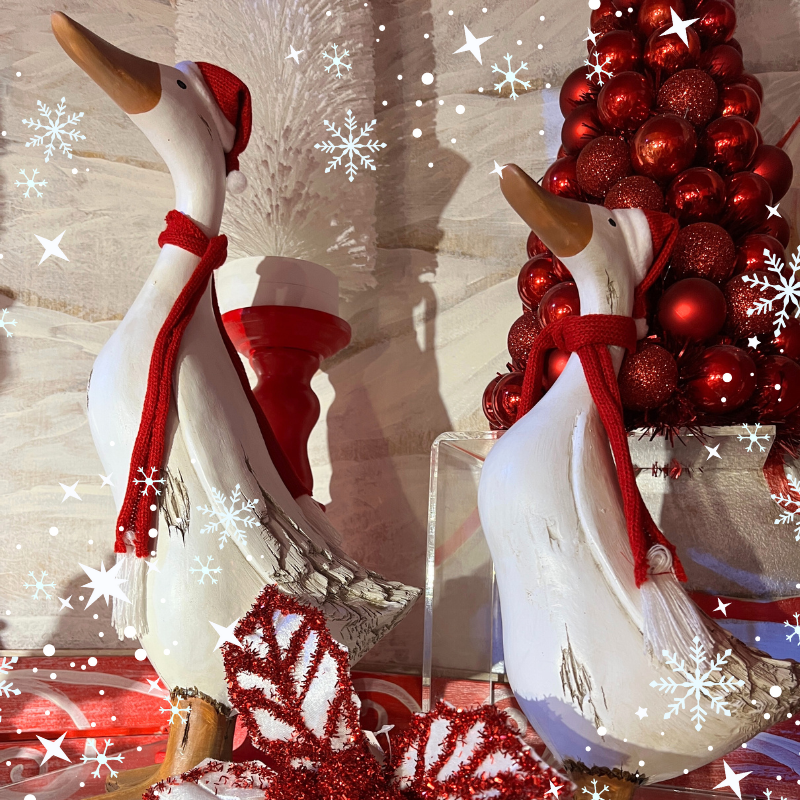 Decorative Christmas geese with red scarves and ornaments in the wrapped in red room in christmas land 2025 at dewayne's