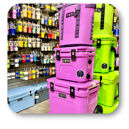 Stack of pink and green YETI coolers and an assortment of yeti tumblers in the gift shop at Dewayne's in Selma, NC minutes from Raleigh, Cary, Clayton, Garner, Smithfield, Goldsboro