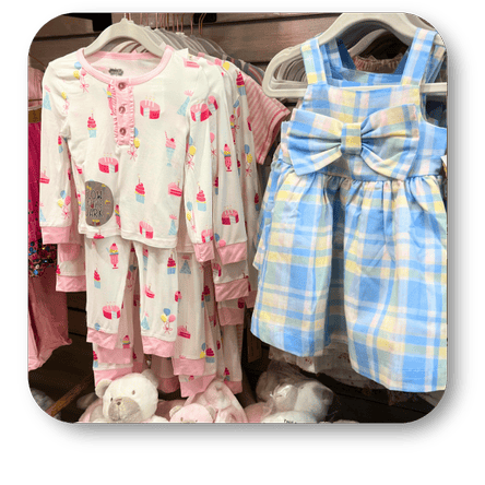 Children's clothing including pajamas with cupcake pattern and a checkered dress with a bow in the gift shop at Dewayne's in Selma, NC minutes from Raleigh, Cary, Clayton, Garner, Smithfield, Goldsboro