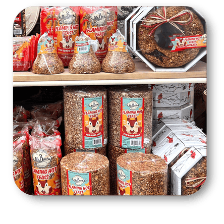 Assorted packages of Flaming Hot Feast bird food  in the greenhouse atrium at Dewayne's in Selma, NC minutes from Raleigh, Cary, Clayton, Garner, Smithfield, Goldsboro