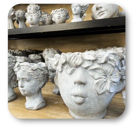 Decorative stone face planters  in the greenhouse atrium at Dewayne's in Selma, NC minutes from Raleigh, Cary, Clayton, Garner, Smithfield, Goldsboro