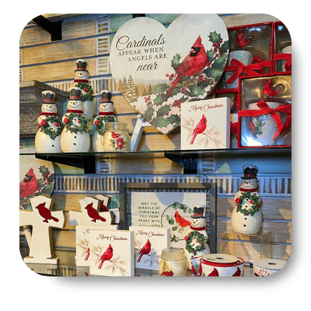 Collection of Christmas-themed decor items including cardinals, snowmen, and festive signs in christmas land at Dewayne's in Selma, NC minutes from Raleigh, Cary, Clayton, Garner, Smithfield, Goldsboro