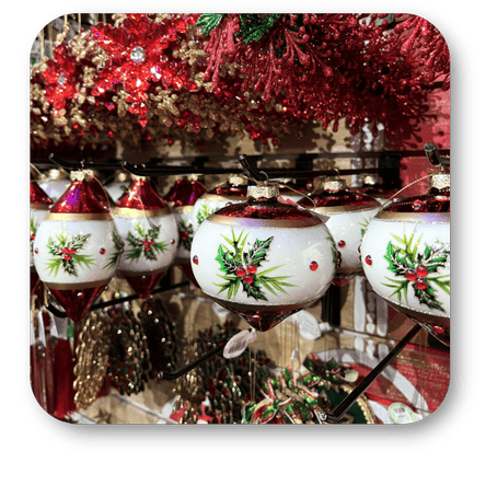 Decorative Christmas ornaments with holly design found in the grand entrance room of Christmas land at Dewayne's in Selma, NC minutes from Raleigh, Cary, Clayton, Garner, Smithfield, Goldsboro