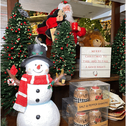 Decorative Christmas santa, snowman, miniature trees, and salt and pepper shakers in the country christmas room in christmas land 2025 at Dewayne's in Selma, NC