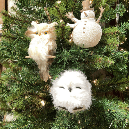 Decorative owl and snowman ornaments on a Christmas tree with lights in the country christmas room in christmas land 2025 at Dewayne's in Selma, NC