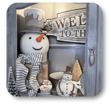 Decorative display with snowmen and a 'Welcome' sign in a rustic setting in the country Christmas room of Christmas Land at Dewayne's in Selma, NC minutes from Raleigh, Cary, Clayton, Garner, Smithfield, Goldsboro