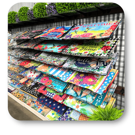 Display of colorful decorative door mats  in the greenhouse atrium at Dewayne's in Selma, NC minutes from Raleigh, Cary, Clayton, Garner, Smithfield, Goldsboro