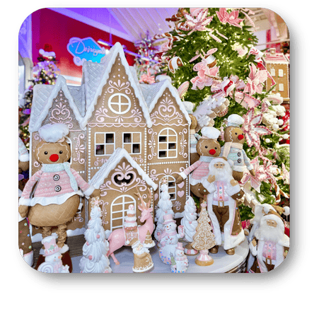 Decorative gingerbread house with gingerbread men and Christmas tree in the background in the Kringle's Kitchen room in christmas land at Dewayne's in Selma, NC minutes from Raleigh, Cary, Clayton, Garner, Smithfield, Goldsboro