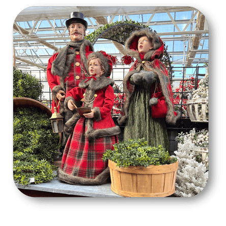 Decorative Christmas caroler figures in a greenhouse setting at Dewayne's in Selma, NC minutes from Raleigh, Cary, Clayton, Garner, Smithfield, Goldsboro