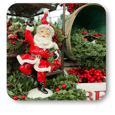 Decorative Santa Claus figure with wreaths and berries in a festive setting at Dewayne's in Selma, NC minutes from Raleigh, Cary, Clayton, Garner, Smithfield, Goldsboro
