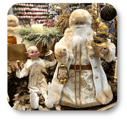 Decorative figure of a gold bearded santa and an elf in the gold and glamour room in christmas land at Dewayne's in Selma, NC minutes from Raleigh, Cary, Clayton, Garner, Smithfield, Goldsboro